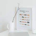 Boobie art print showcasing diverse breast shapes and colors in minimalist line art style.