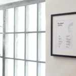 Full vertical shot of the Elon Musk Success Poster framed on a clean white wall, showing all 10 laws of success clearly.