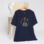 Festival astronaut meditation graphic tee with space planets design, perfect for EDM rave outfits and cosmic streetwear looks.