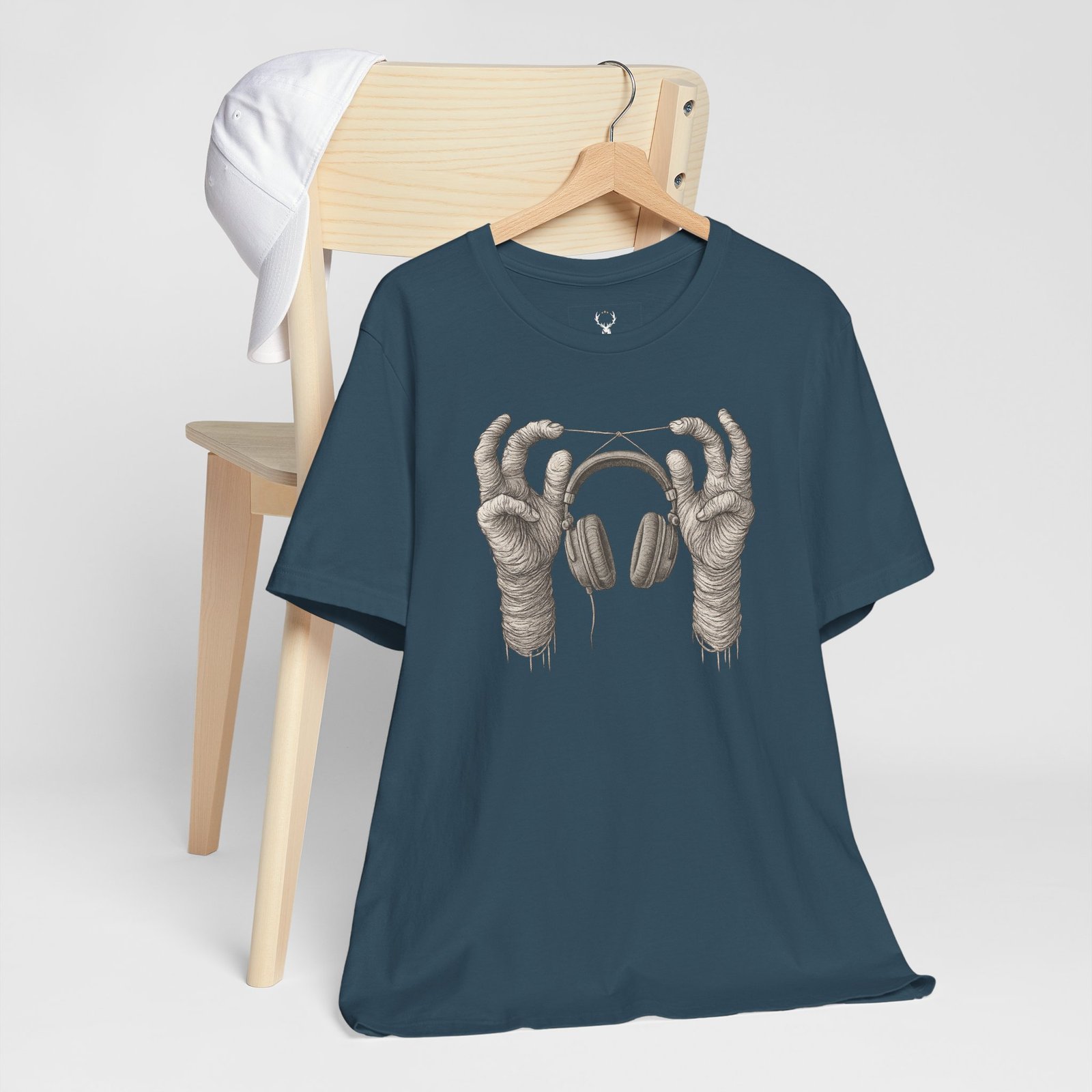 Skeleton hands holding headphones graphic tee, designed for EDM DJs, ravers, and underground streetwear fans.