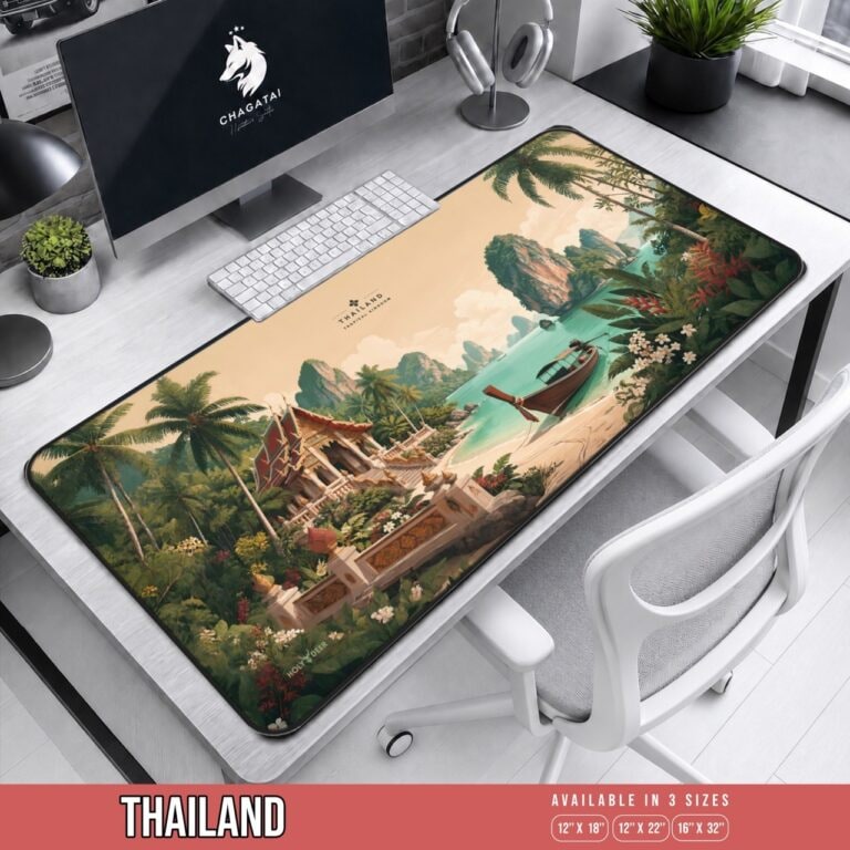 Thailand beach desk mat with a red-roofed Thai temple, longtail boat, limestone islands, tropical flowers, and black stitched border